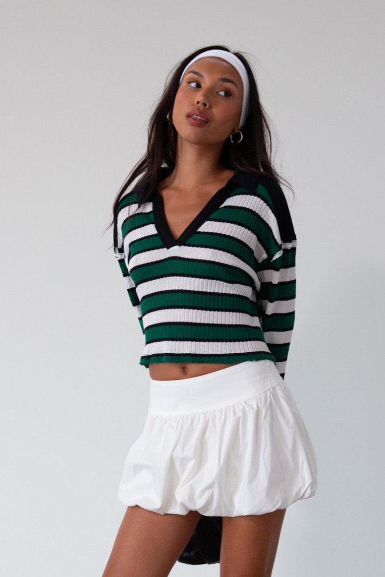 Striped ribbed knit crop top. Collar neckline. Long sleeves. Raw hem. Unlined. green and white stripe sweater long sleeve top