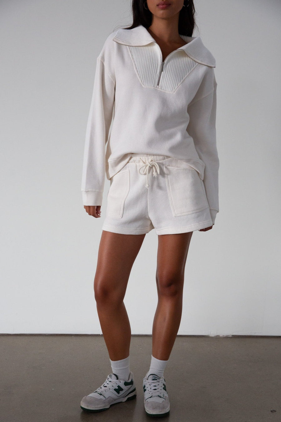 Knit shorts. Elastic waist and drawstring closure. Front pockets. Fleece lining. lounge shorts. sweat shorts. ivory sweat shorts. cream sweat shorts. loungewear