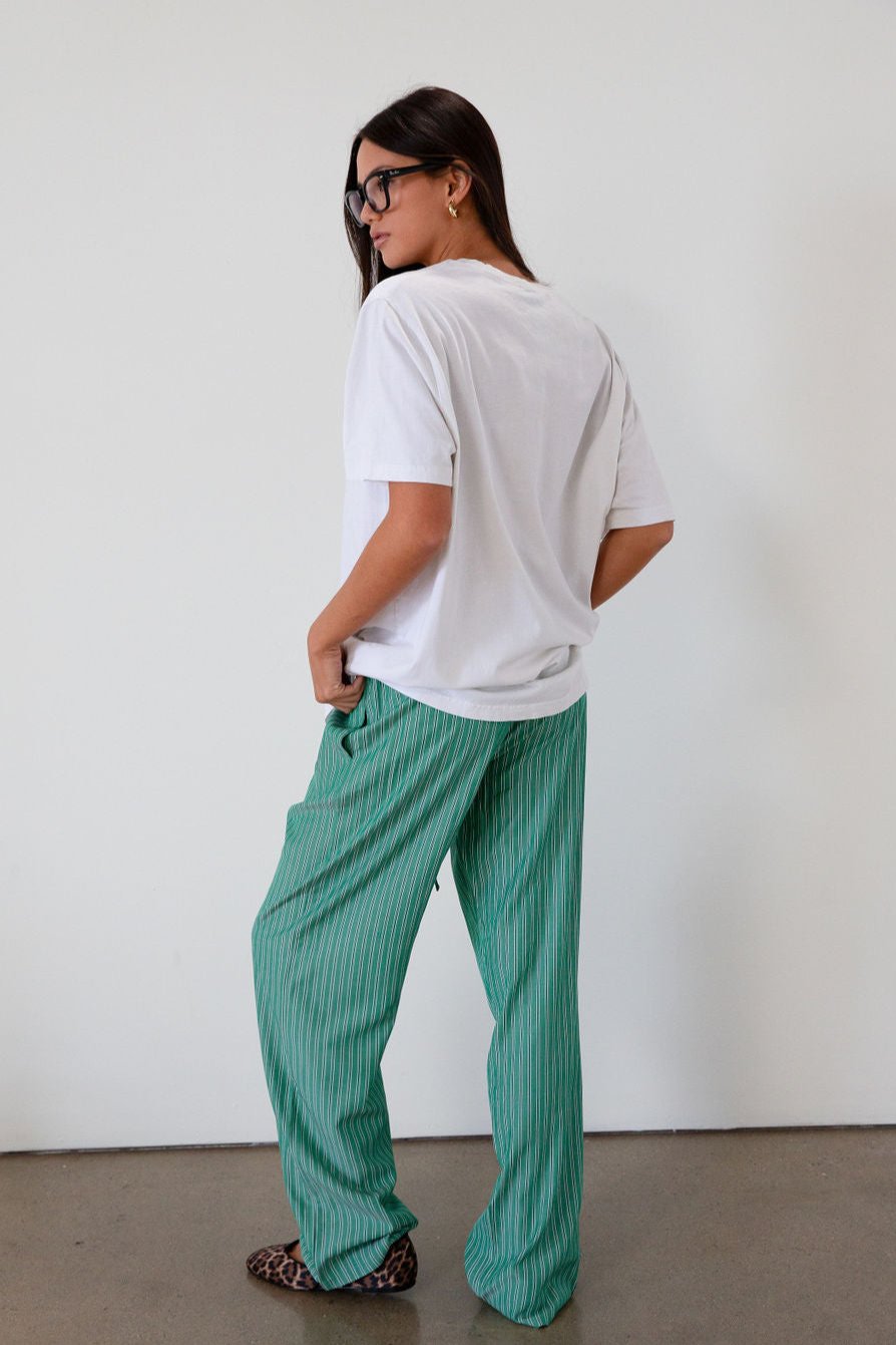 green Striped woven pants. Elastic waistband with drawstring closure. Side pockets. Unlined. fall transition outfit. lounge outfit. cute casual outfit