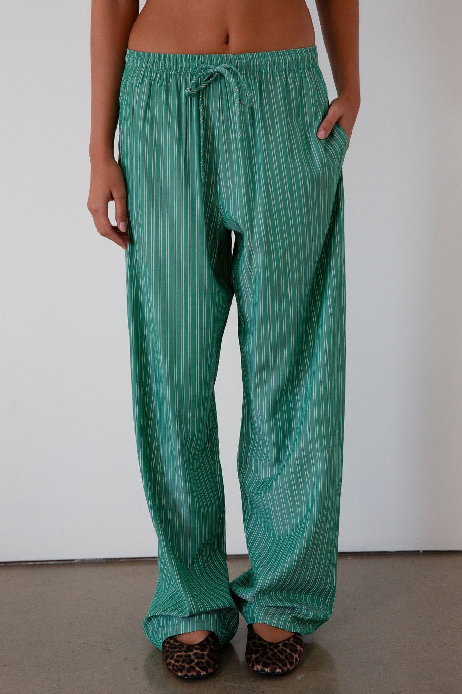 green Striped woven pants. Elastic waistband with drawstring closure. Side pockets. Unlined. fall transition outfit. lounge outfit. cute casual outfit