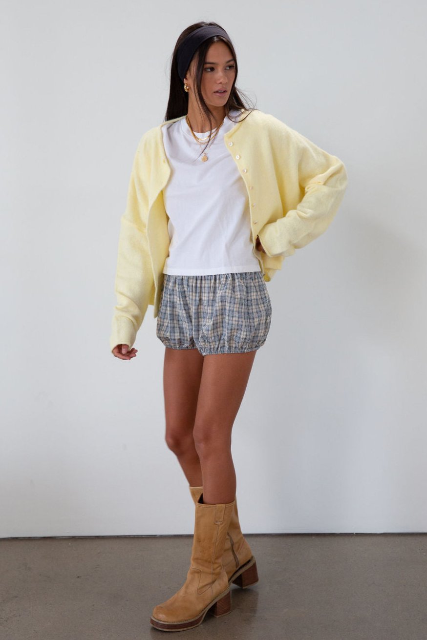 Fuzzy butter yellow knit cardigan. Crewneck. Front button down closures. Long sleeves. Unlined. fall transition outfit.
