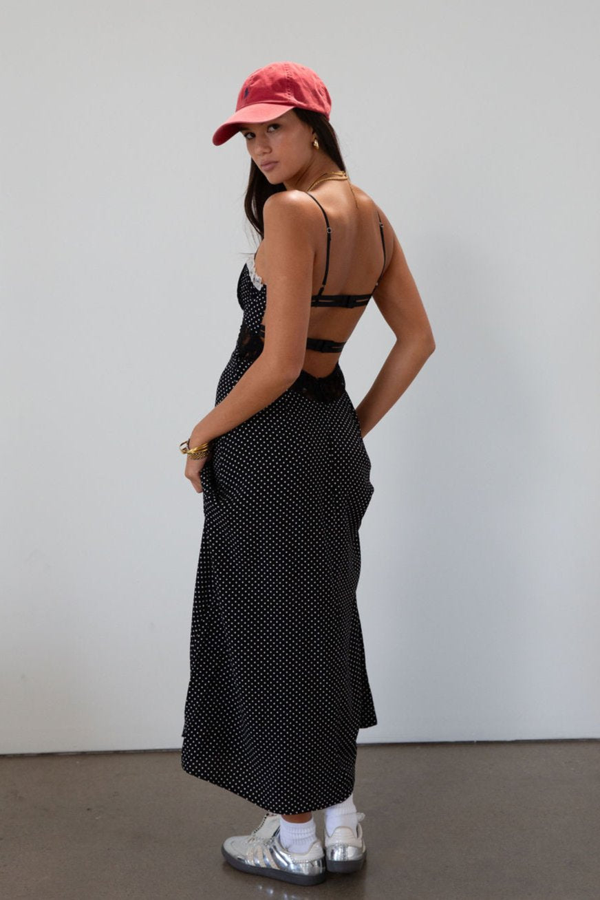 Polka dot printed woven midi dress. Lace details. Adjustable straps. Underwire cups. Back hook and eyes and zipper closures. Unlined.
