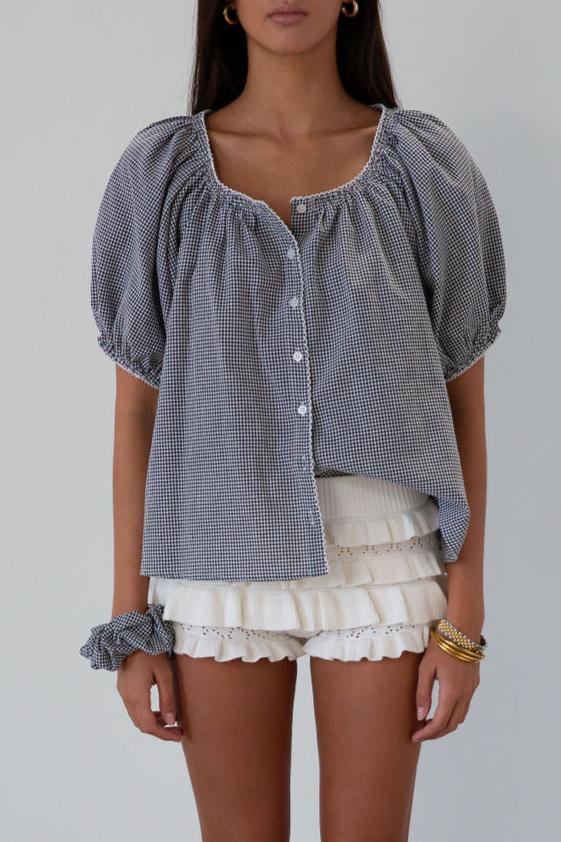 white Knit ruffle eyelet mini shorts.