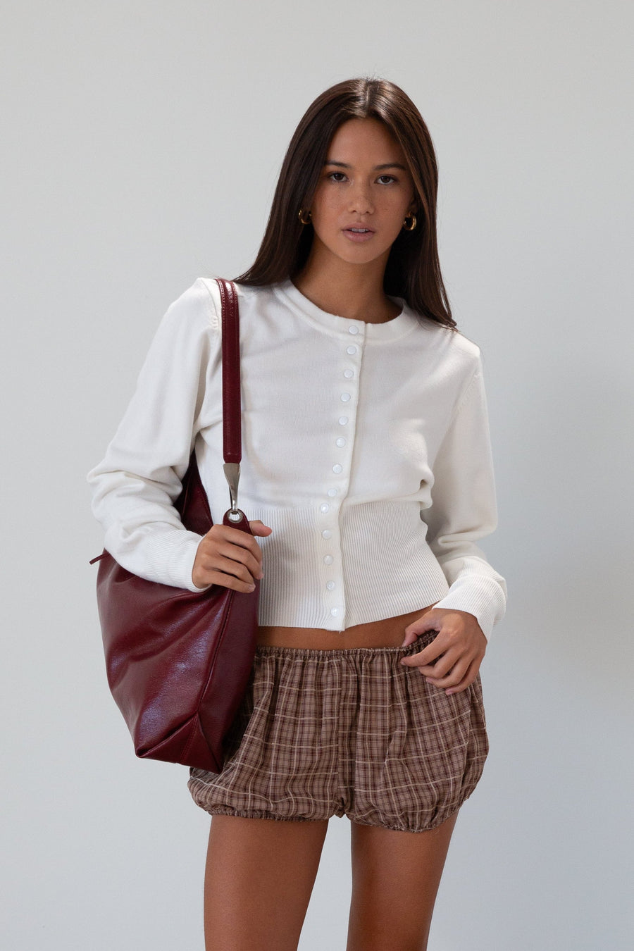 Vegan leather bag. Detachable top strap. Detachable shoulder strap. Top zipper closure. Fully lined. Inner pockets.