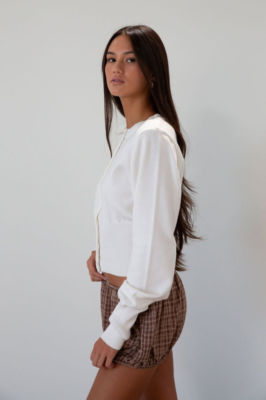 Knit cardigan. Long sleeves. Front button down closure. Banded hems. Unlined. white cardigan. fall transition outfit.
