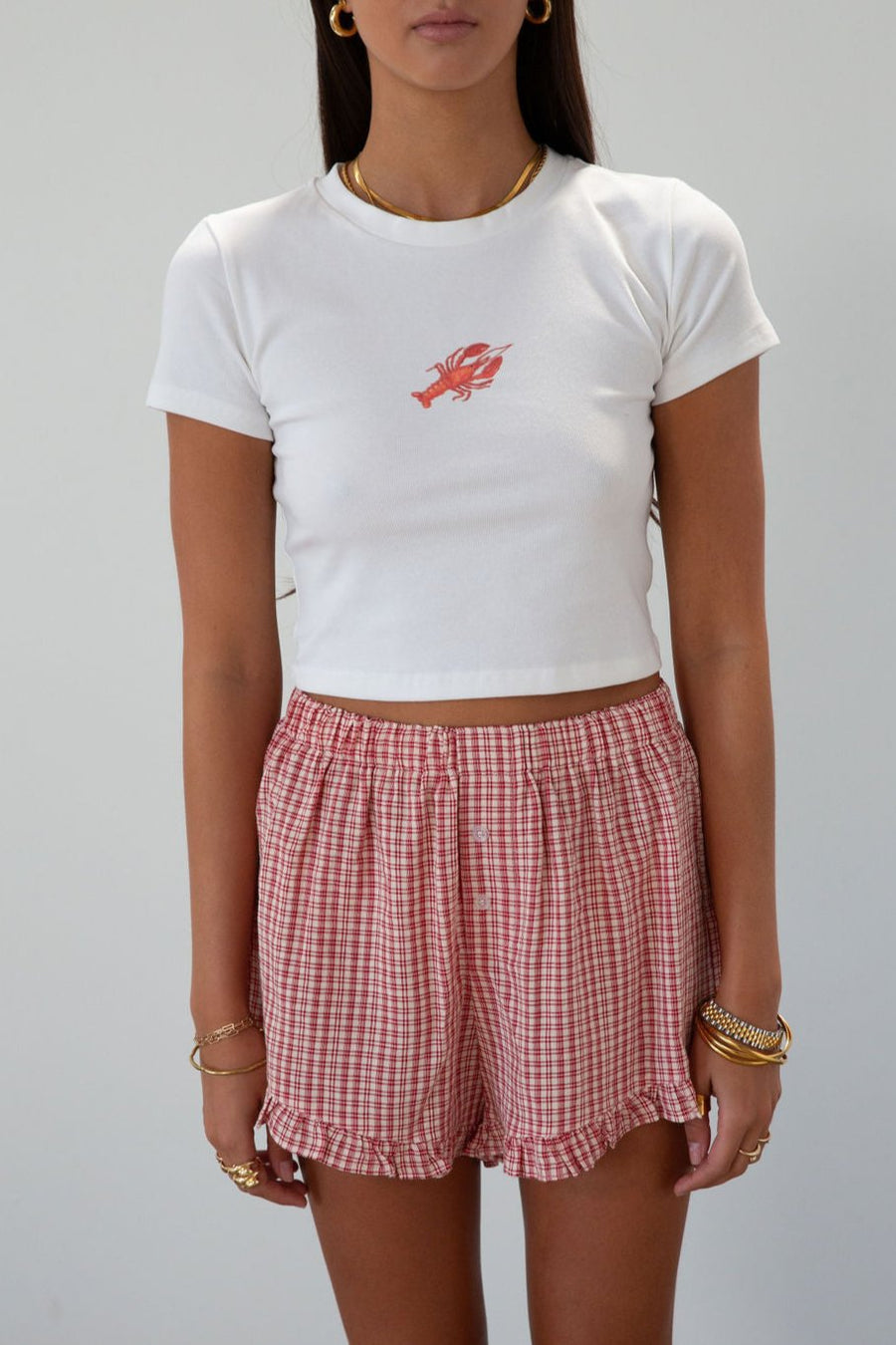 Graphic printed knit crop tee. Crewneck. Short sleeves. Unlined. lobster tee. baby lobster tee. white baby tee