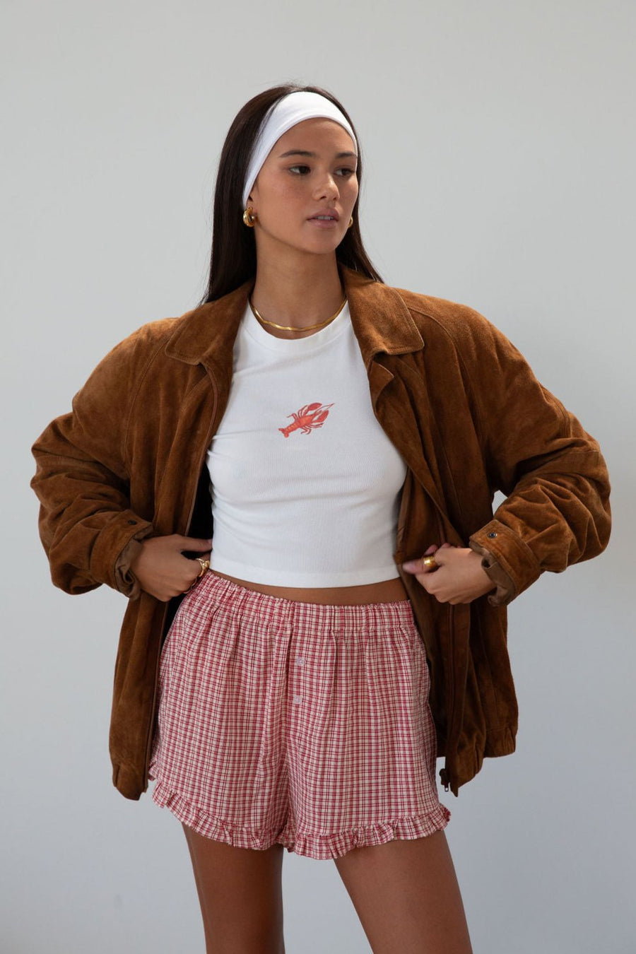 Checkered woven shorts. Elastic waist. Faux button fly. Ruffle trim hem. Unlined. red checkered shorts