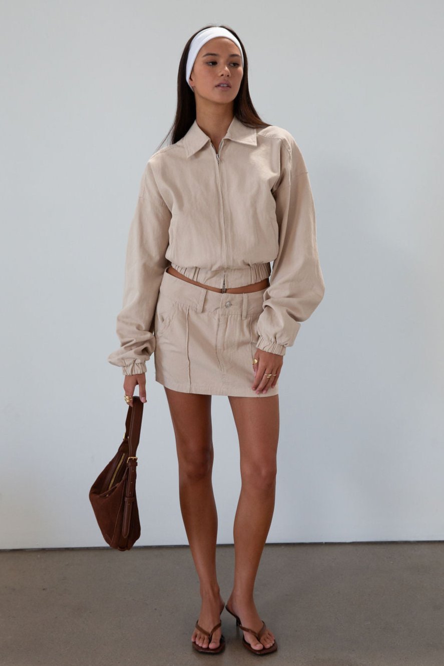 Denim skirt. Button and zipper fly. Four pocket construction. Unlined. tan denim skirt. fall outfit
