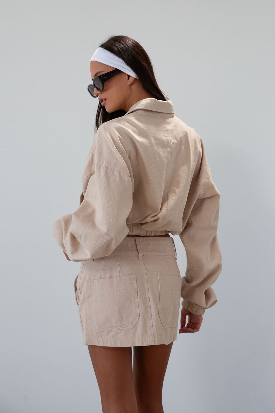 Denim skirt. Button and zipper fly. Four pocket construction. Unlined. tan denim skirt. fall outfit