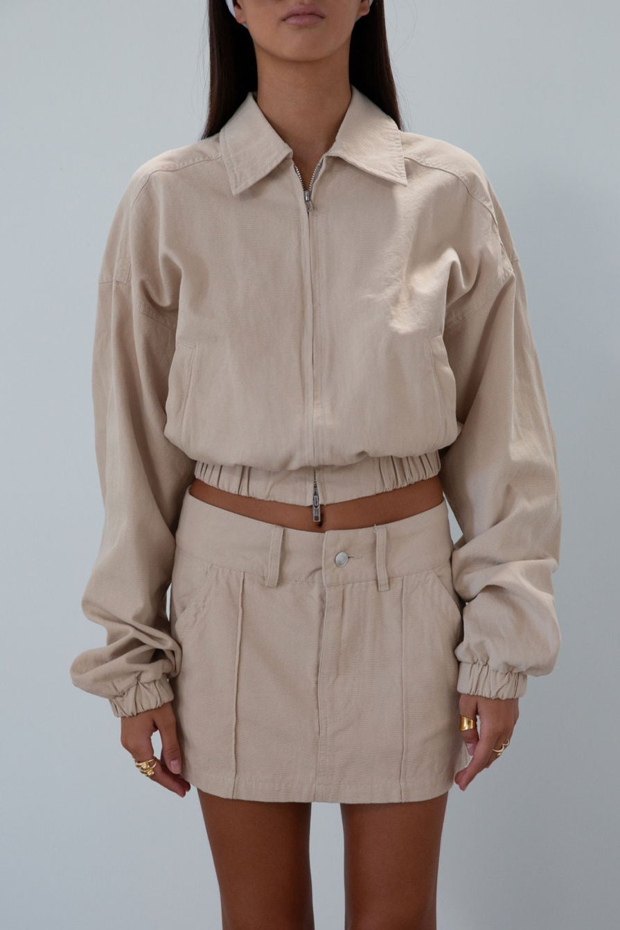 Denim skirt. Button and zipper fly. Four pocket construction. Unlined. tan denim skirt. fall outfit