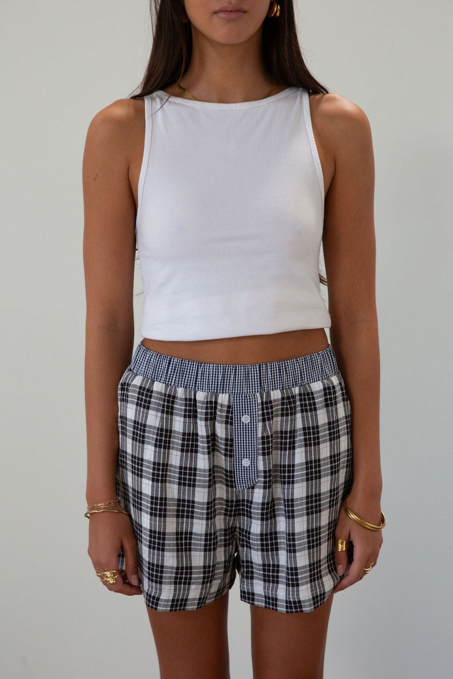 Plaid woven shorts. Elastic waistband. Faux button fly. Side pockets. Fully lined. plaid boxer shorts. black and white boxer shorts. fall outfit