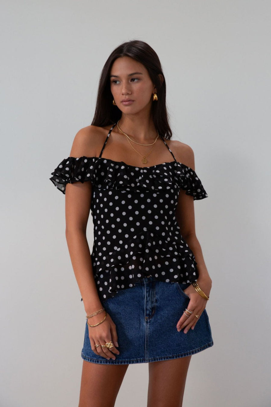 Polka dot printed chiffon crop top. Ruffle trim. Elastic off the shoulder short sleeves. Front tie closure. Boning in bodice. Back hook and eye and zipper closures. Fully lined. black polka dot top. going out top fall top. fall outfit.