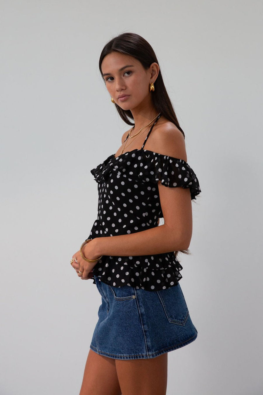 Polka dot printed chiffon crop top. Ruffle trim. Elastic off the shoulder short sleeves. Front tie closure. Boning in bodice. Back hook and eye and zipper closures. Fully lined. black polka dot top. going out top fall top. fall outfit.