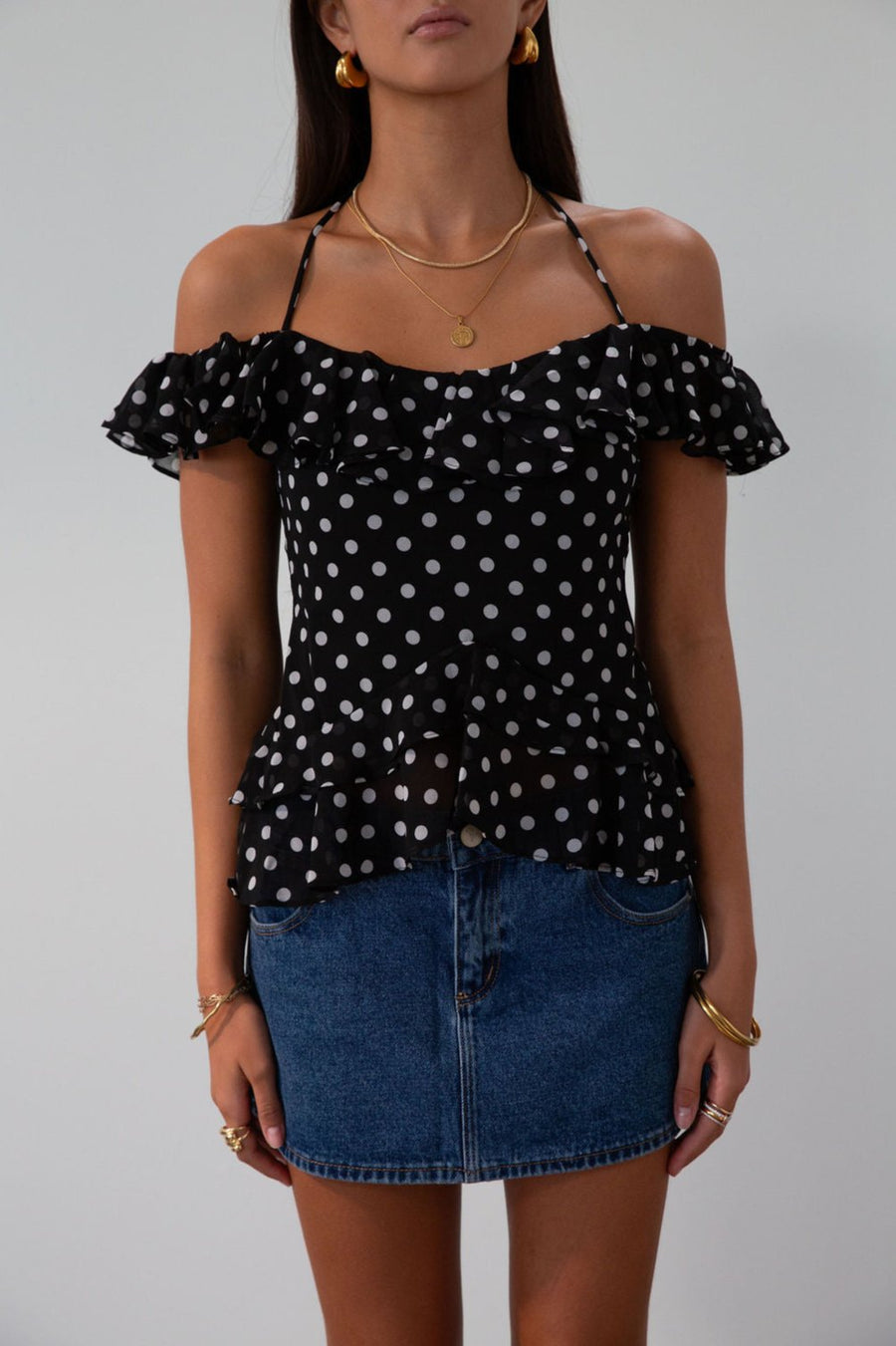 Polka dot printed chiffon crop top. Ruffle trim. Elastic off the shoulder short sleeves. Front tie closure. Boning in bodice. Back hook and eye and zipper closures. Fully lined. black polka dot top. going out top fall top. fall outfit.