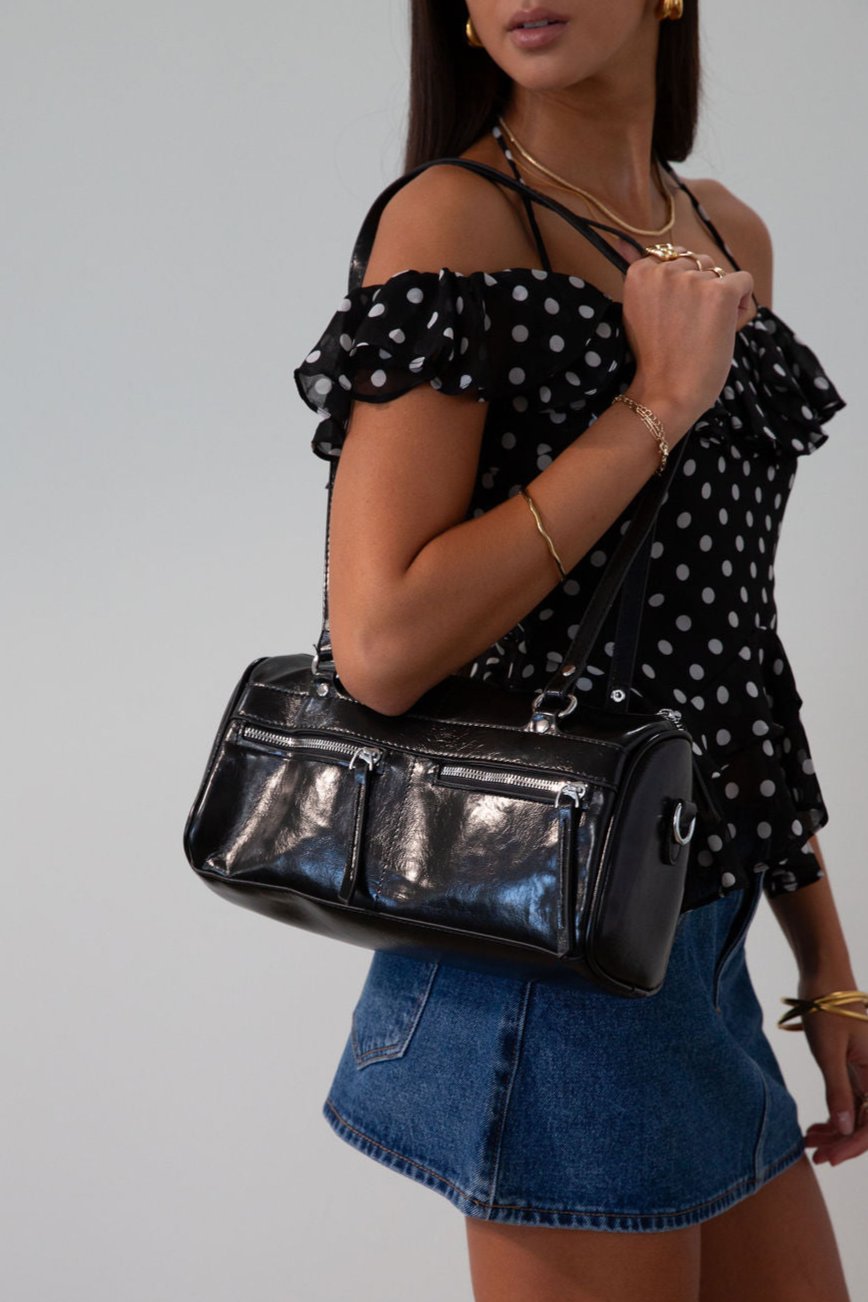 Vegan leather bag. Fixed top straps. Adjustable/detachable strap. Top zipper closure. Outer zipper pockets. Fully lined with inner zipper pocket.