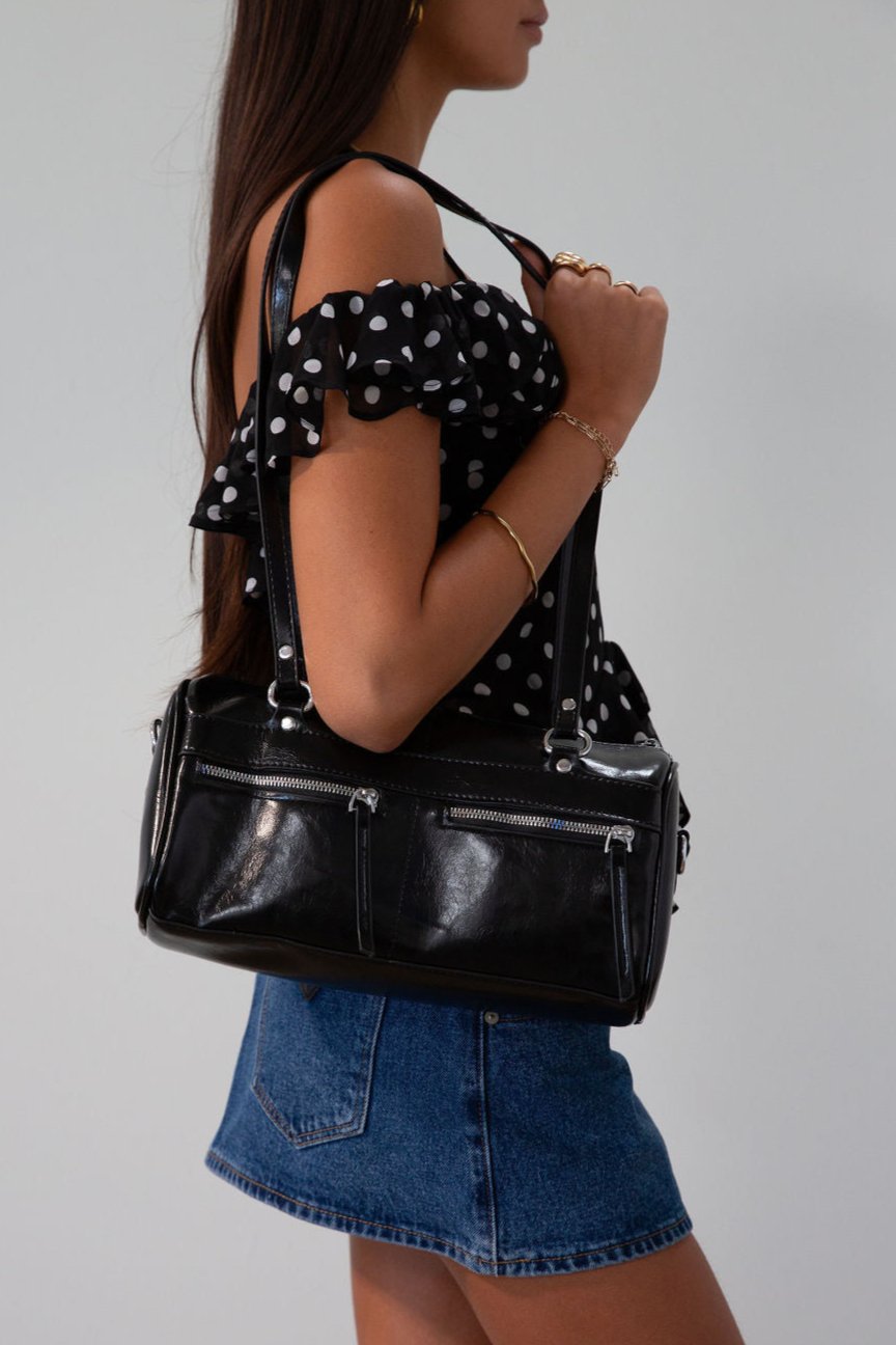 Vegan leather bag. Fixed top straps. Adjustable/detachable strap. Top zipper closure. Outer zipper pockets. Fully lined with inner zipper pocket.