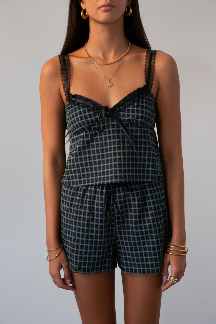 green Checkered woven cropped tank. Lace trim. Adjustable straps. Front tie. Elastic back. Partially lined. fall outfit