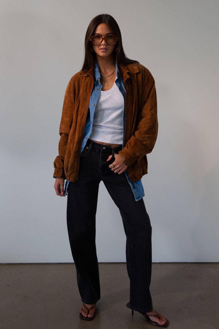 Mid rise bowed straight leg jeans. Button and zipper fly. Five pocket construction. Straight leg bows at the knees for an arched, barrel leg silhouette. Ankle length crop with a clean hem. No stretch. BLACK DENIM JEANS