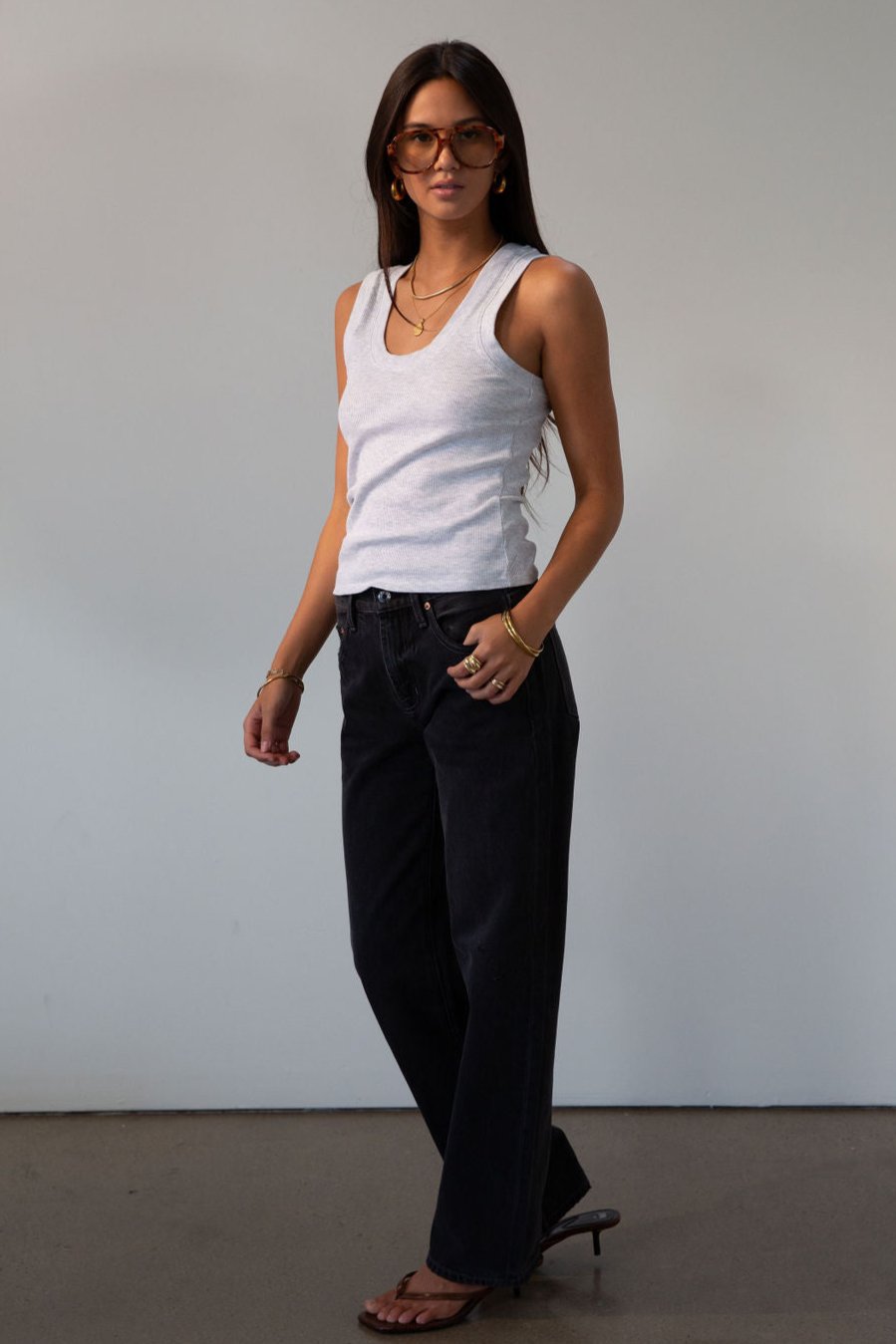Mid rise bowed straight leg jeans. Button and zipper fly. Five pocket construction. Straight leg bows at the knees for an arched, barrel leg silhouette. Ankle length crop with a clean hem. No stretch. BLACK DENIM JEANS
