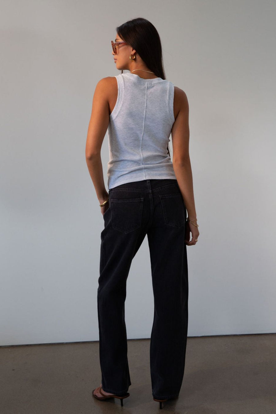 Mid rise bowed straight leg jeans. Button and zipper fly. Five pocket construction. Straight leg bows at the knees for an arched, barrel leg silhouette. Ankle length crop with a clean hem. No stretch. BLACK DENIM JEANS