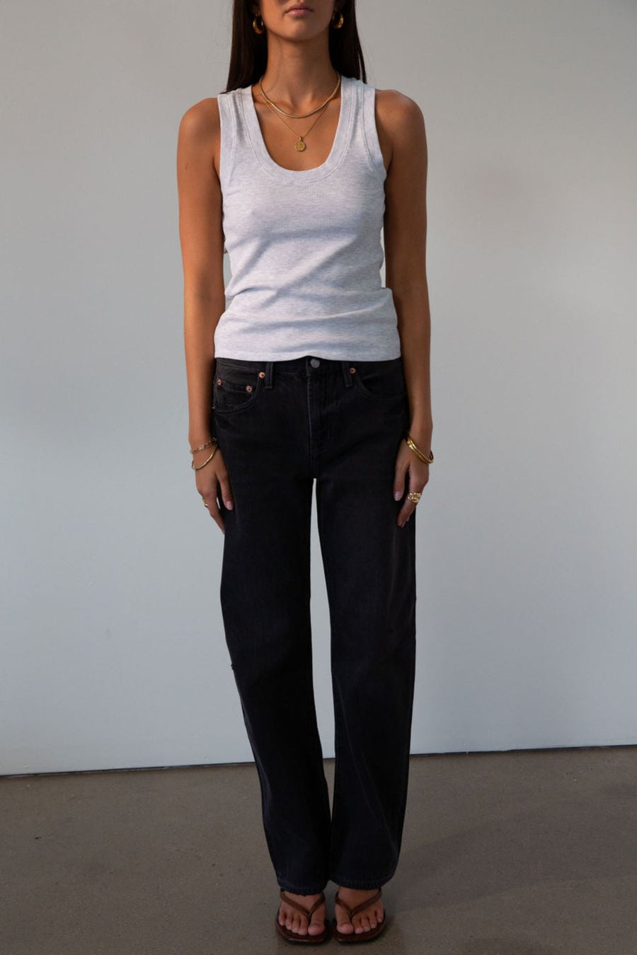 Mid rise bowed straight leg jeans. Button and zipper fly. Five pocket construction. Straight leg bows at the knees for an arched, barrel leg silhouette. Ankle length crop with a clean hem. No stretch. BLACK DENIM JEANS