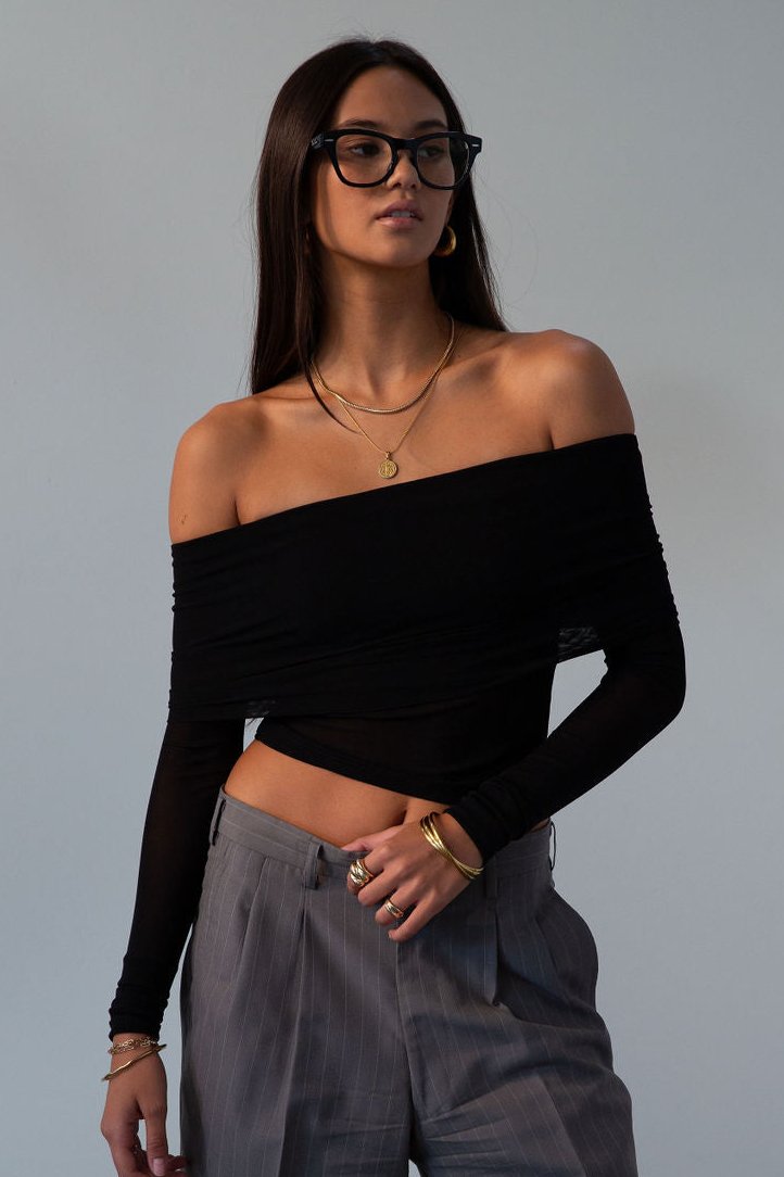 Knit top. Folded off the shoulder neckline. Long sleeves. Unlined/sheer. black off the shoulder long sleeve. fall outfit