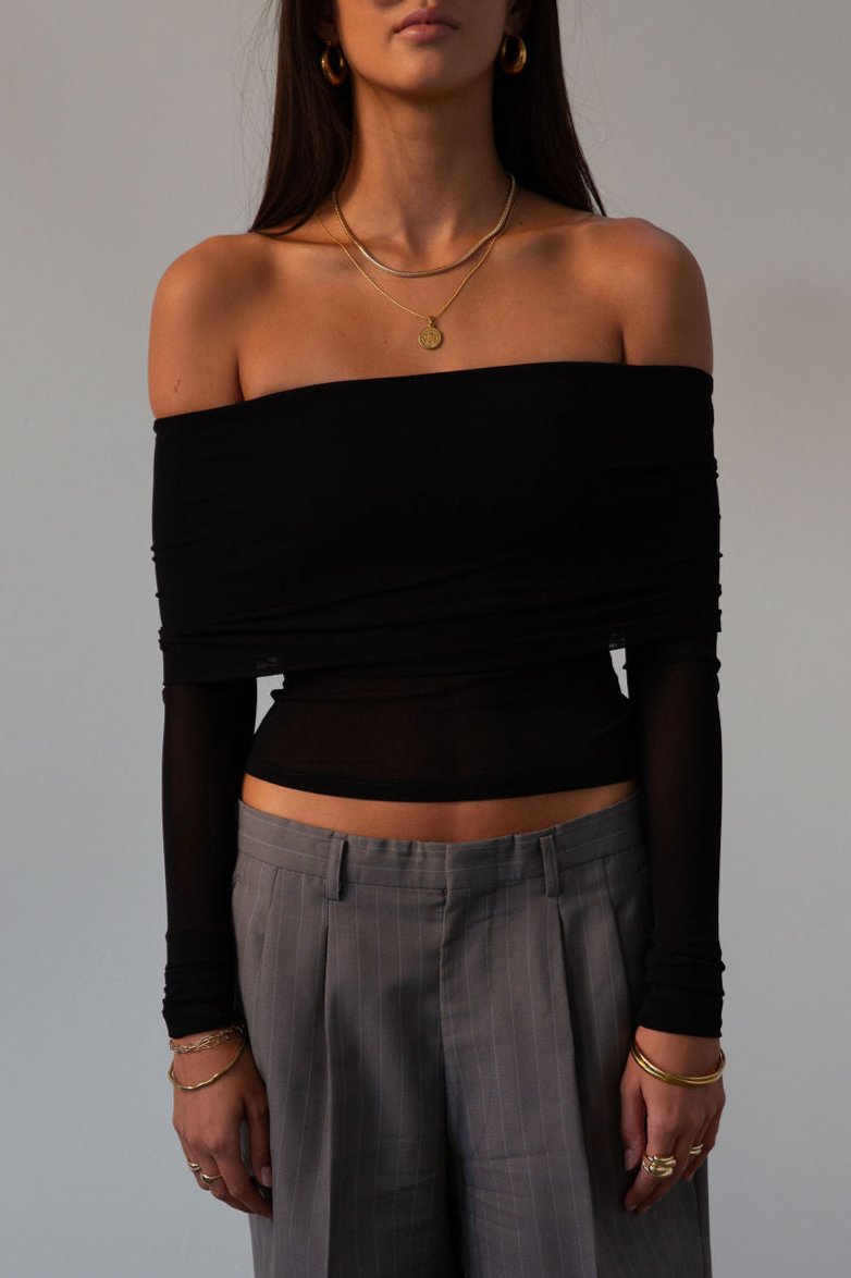 Knit top. Folded off the shoulder neckline. Long sleeves. Unlined/sheer. black off the shoulder long sleeve. fall outfit