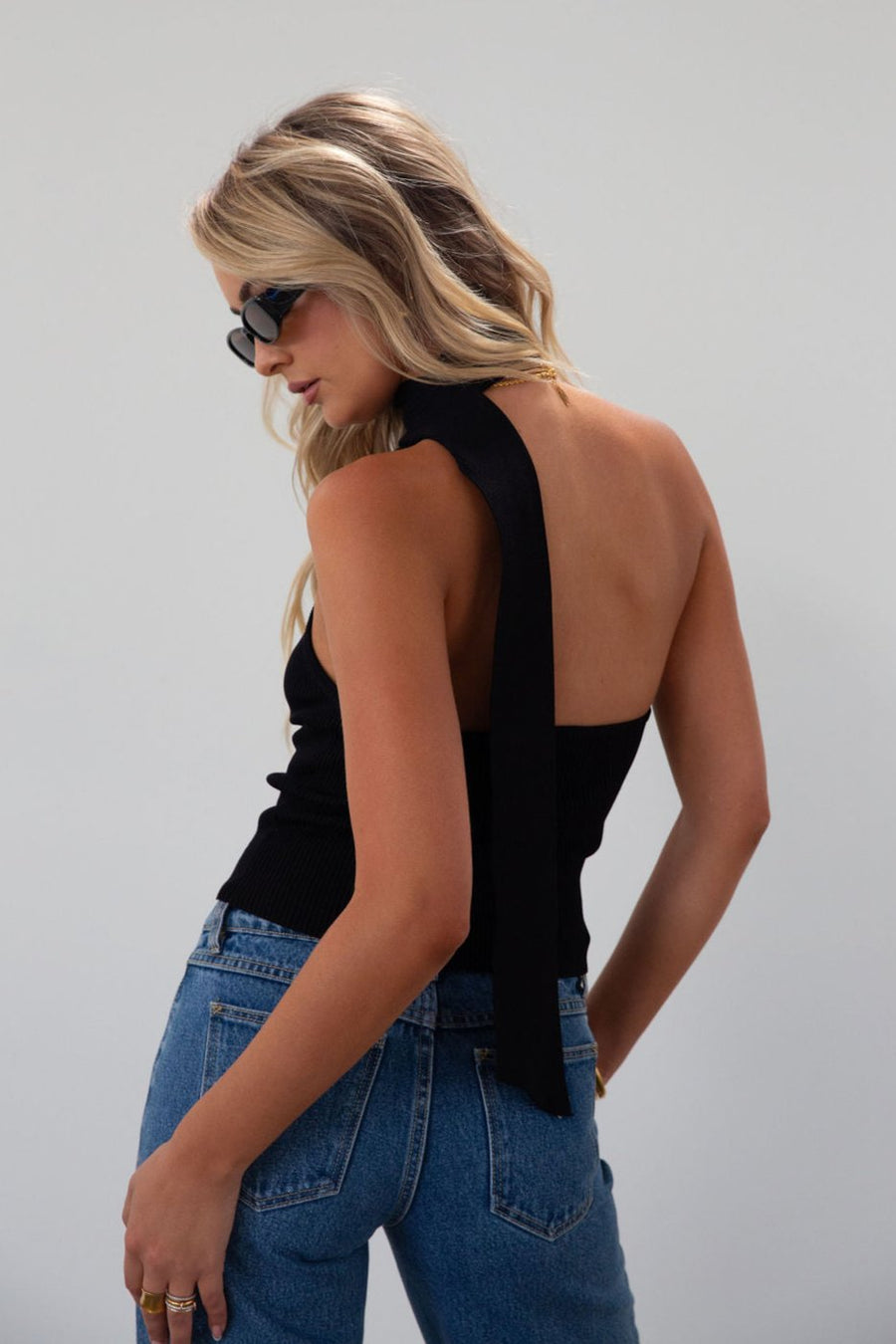 Ribbed knit cropped tank. Asymmetric neckline with adjustable halter tie. Unlined. black tank. fall outfit. fall top. going out top