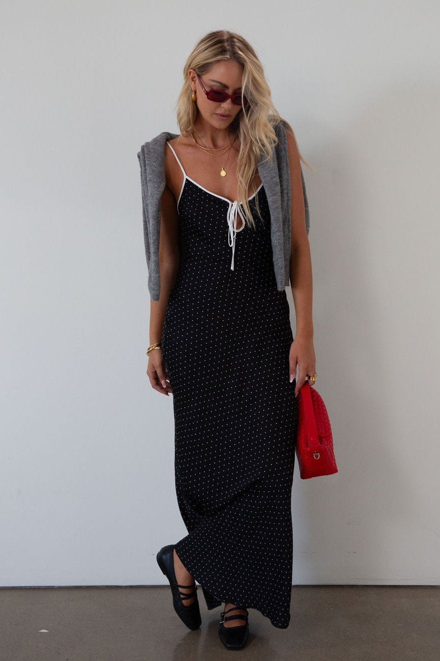 Polka dot satin maxi dress. Adjustable straps. Front tie closure. Unlined. black and white polka dot maxi dress. fall transition dress. black maxi dress