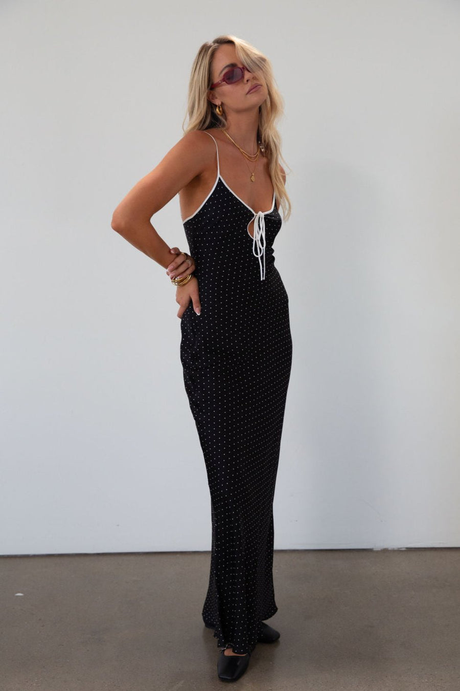 Polka dot satin maxi dress. Adjustable straps. Front tie closure. Unlined. black and white polka dot maxi dress. fall transition dress. black maxi dress