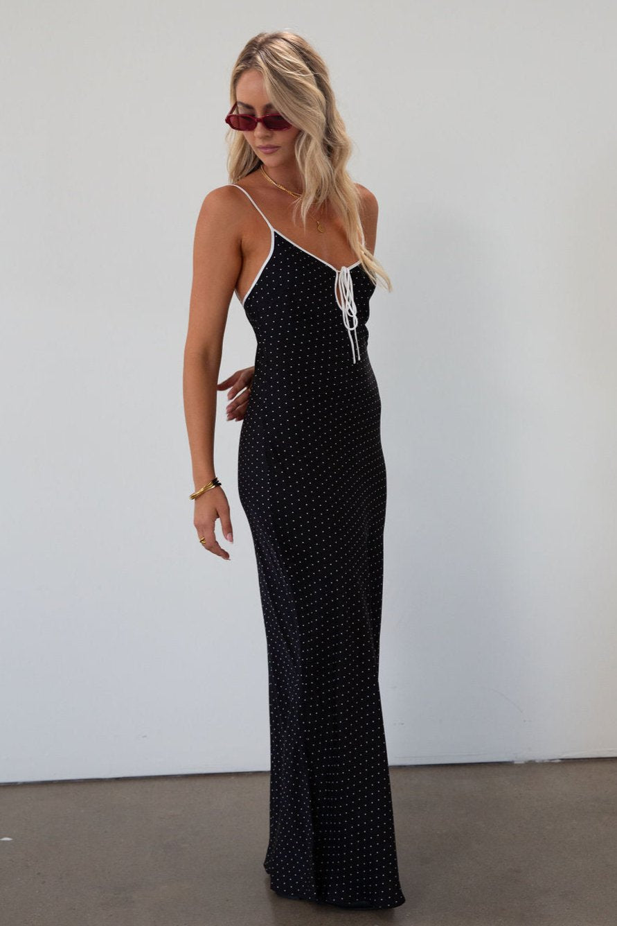 Polka dot satin maxi dress. Adjustable straps. Front tie closure. Unlined. black and white polka dot maxi dress. fall transition dress. black maxi dress
