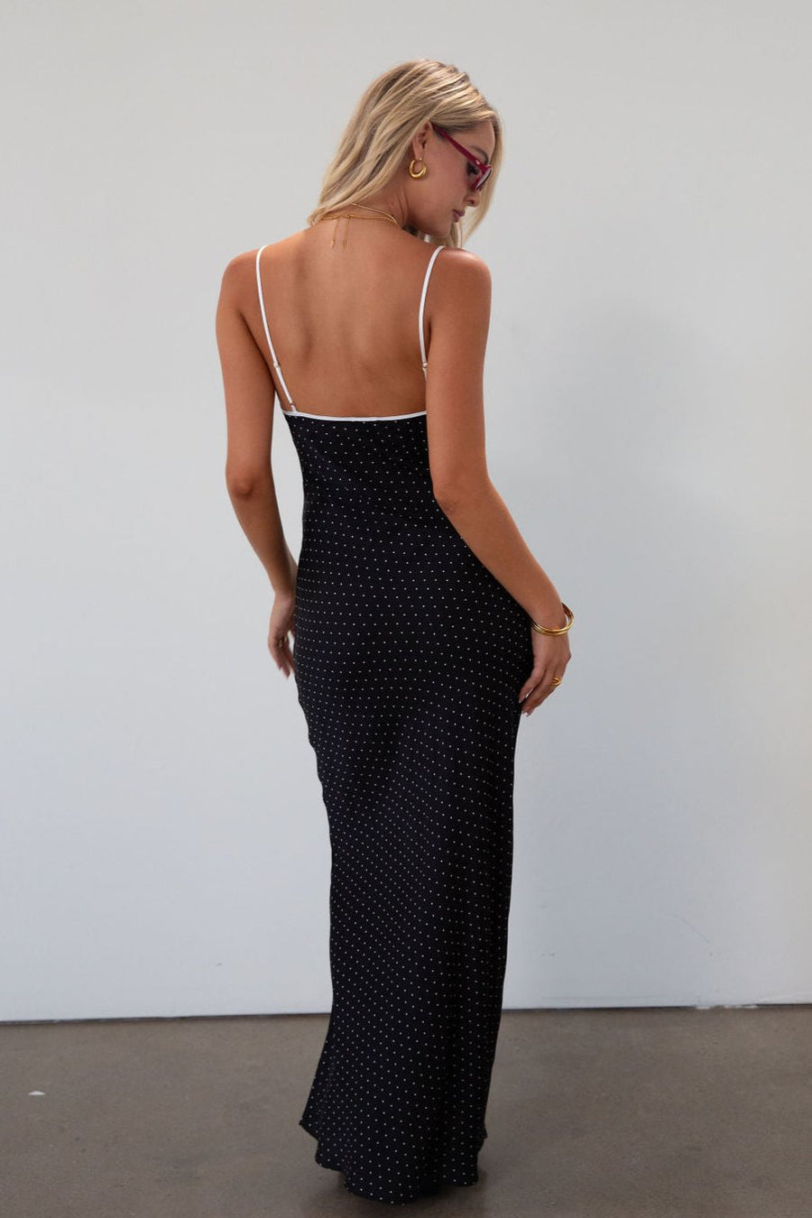Polka dot satin maxi dress. Adjustable straps. Front tie closure. Unlined. black and white polka dot maxi dress. fall transition dress. black maxi dress