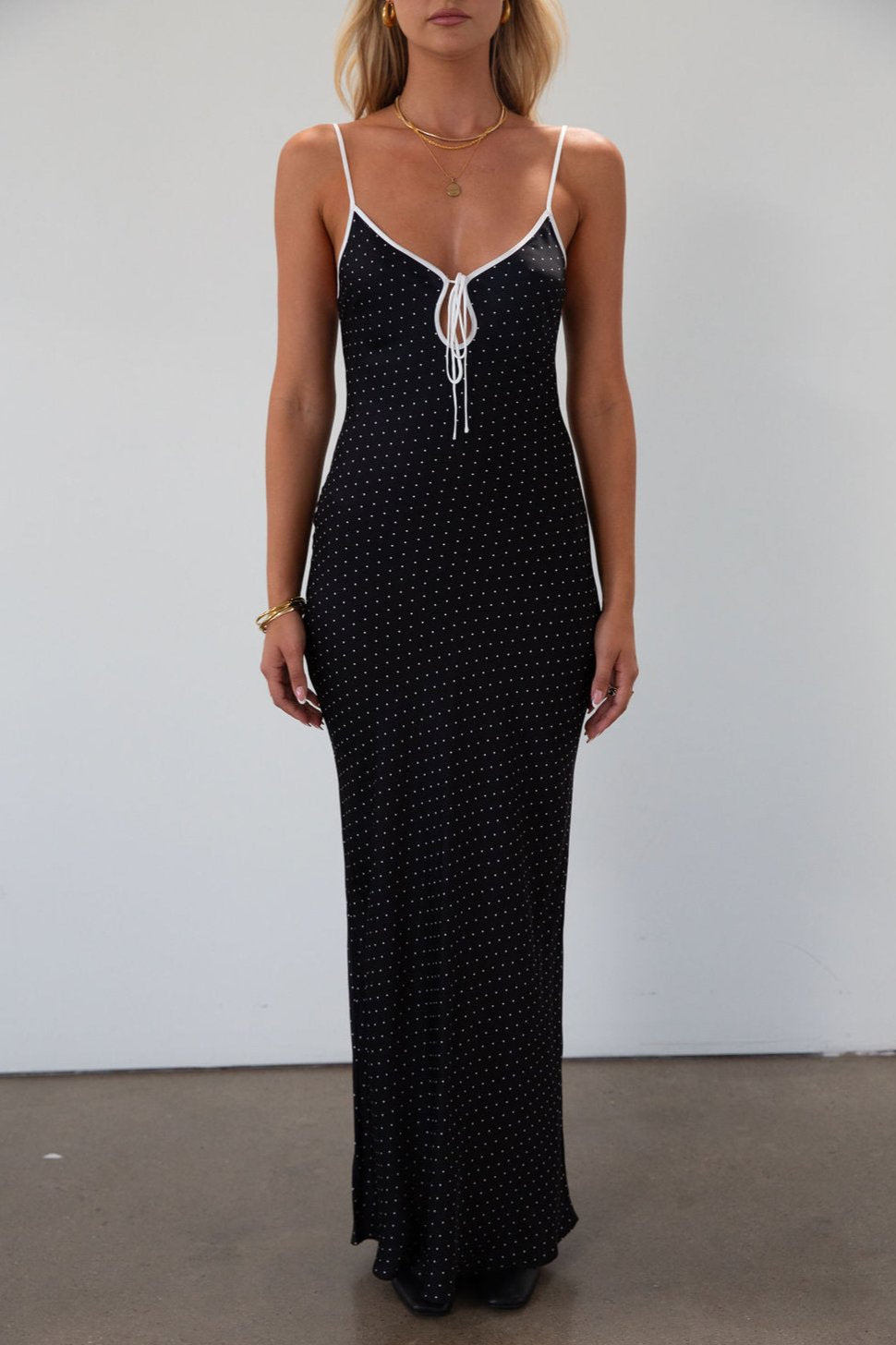 Polka dot satin maxi dress. Adjustable straps. Front tie closure. Unlined. black and white polka dot maxi dress. fall transition dress. black maxi dress