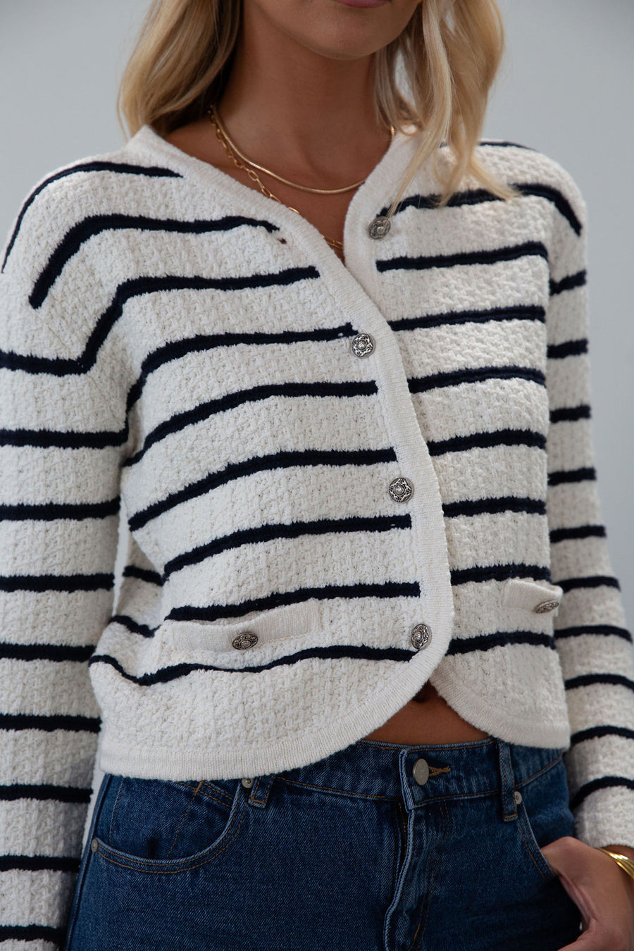 Striped crochet knit cropped cardigan. Front button down closure. Faux front pockets. Unlined. fall outfit. fall top. striped cardigan