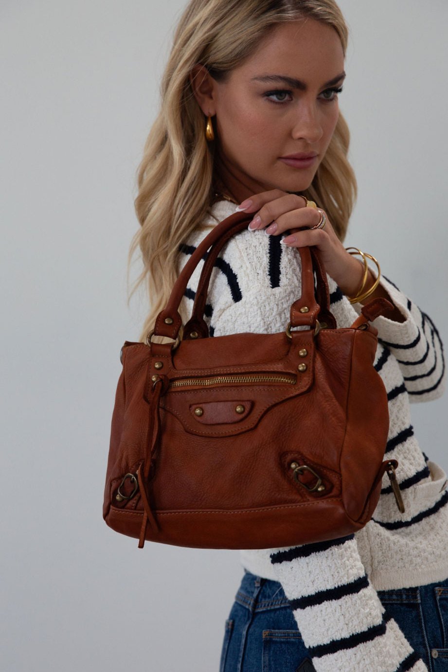 Genuine leather bag. Adjustable/detachable strap. Fixed top handles. Top zipper closure. Front zipper pocket. Fully lined. Inner zipper pocket.