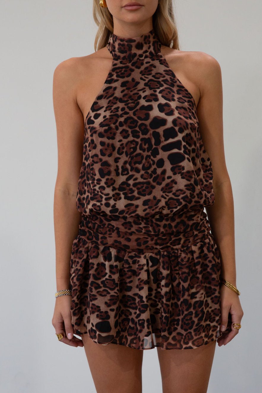 Animal printed chiffon dress. Adjustable halter neckline with tie closure. Side zipper closure. Elastic back. Fully lined.