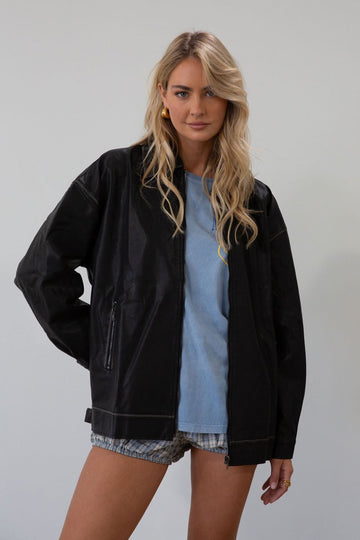 Vegan leather oversized jacket. Collar neckline. Snap button sleeve closures. Exposed front zipper closure. Front pockets with exposed zipper closures. Adjustable sides. Fully lined.&nbsp;