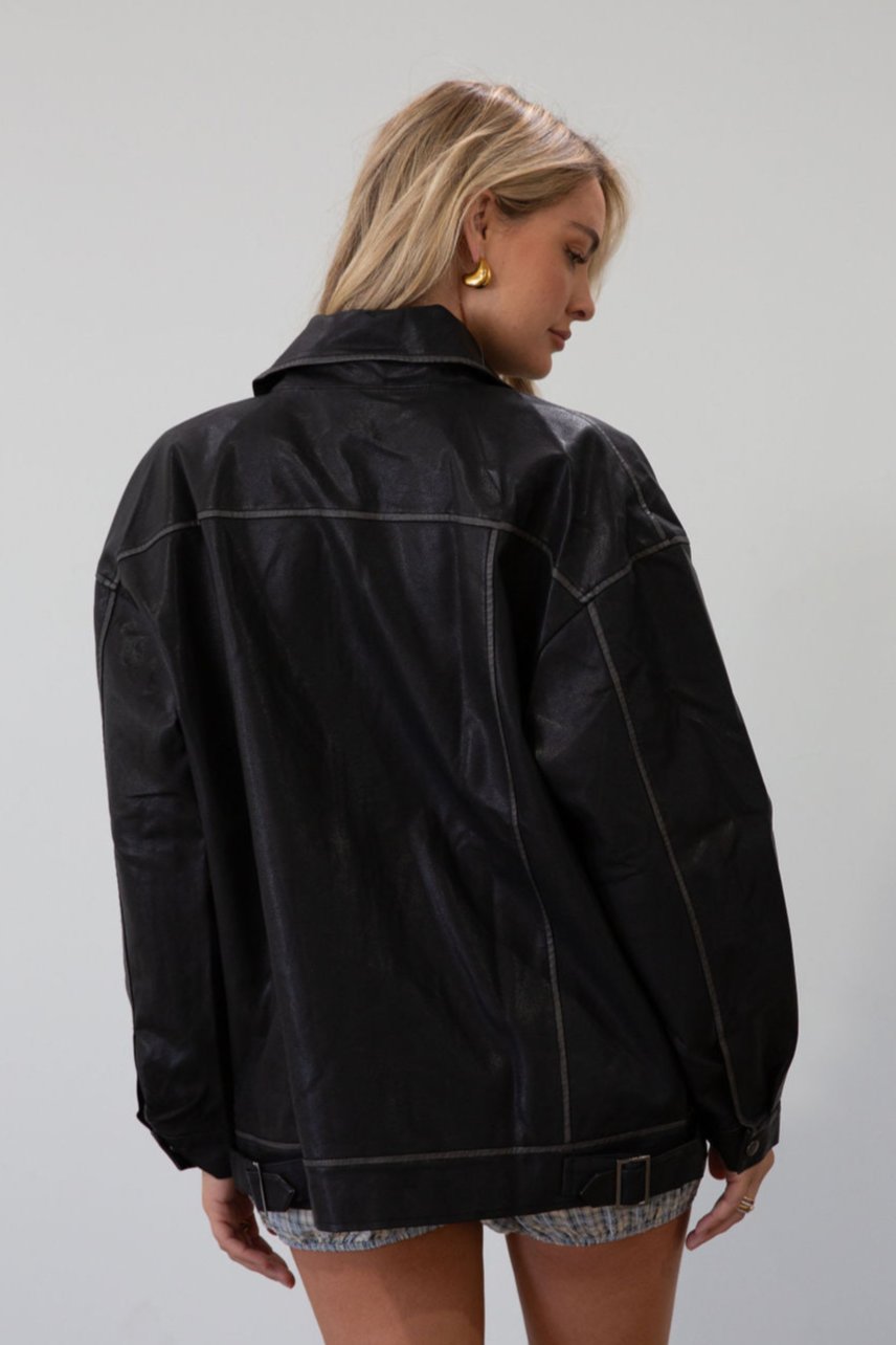 Vegan leather oversized jacket. Collar neckline. Snap button sleeve closures. Exposed front zipper closure. Front pockets with exposed zipper closures. Adjustable sides. Fully lined.&nbsp;