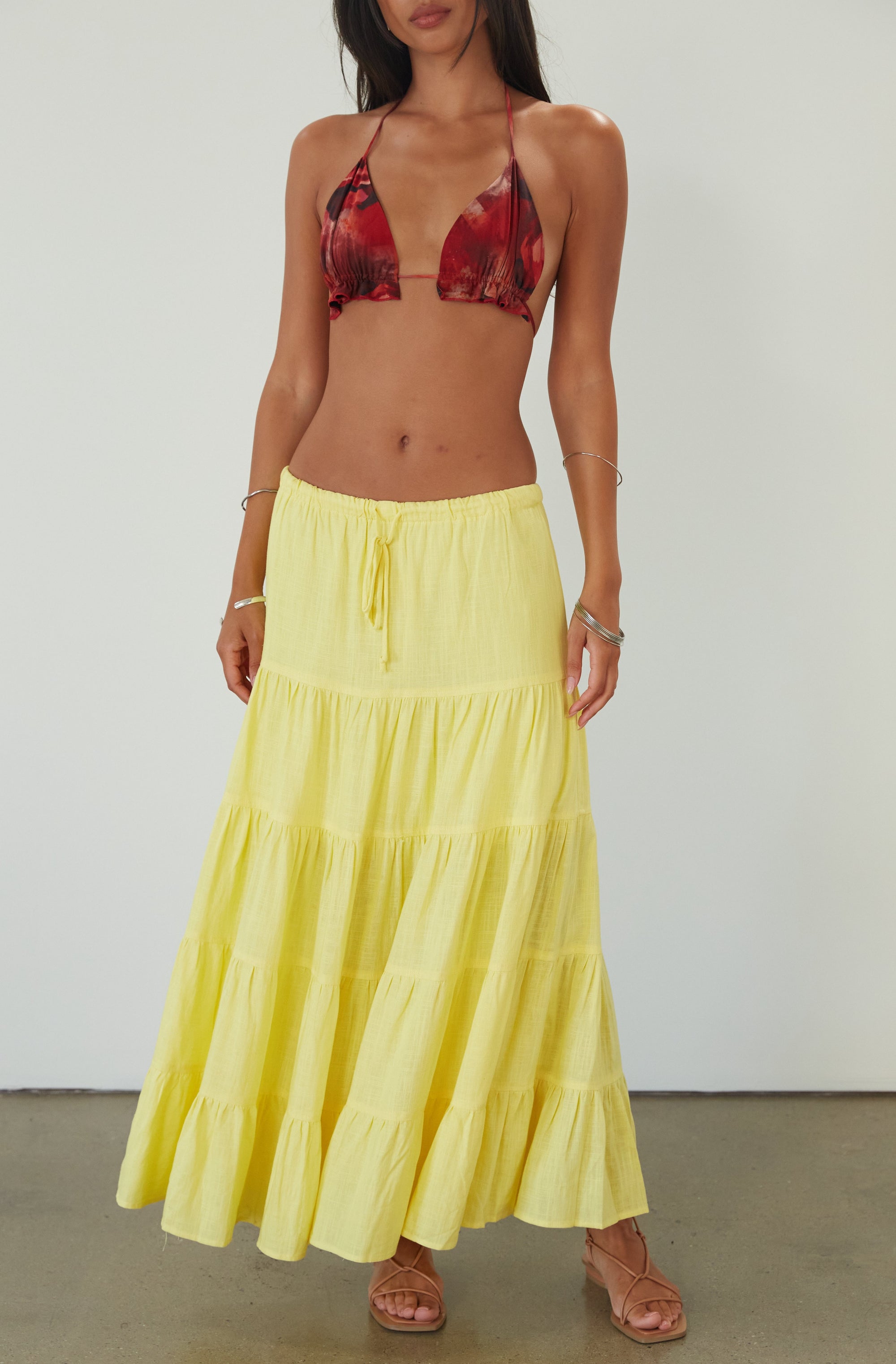 Woven tiered maxi skirt. Elastic waist with drawstring closure. Partially lined. yellow maxi skirt. summer maxi skirt. 