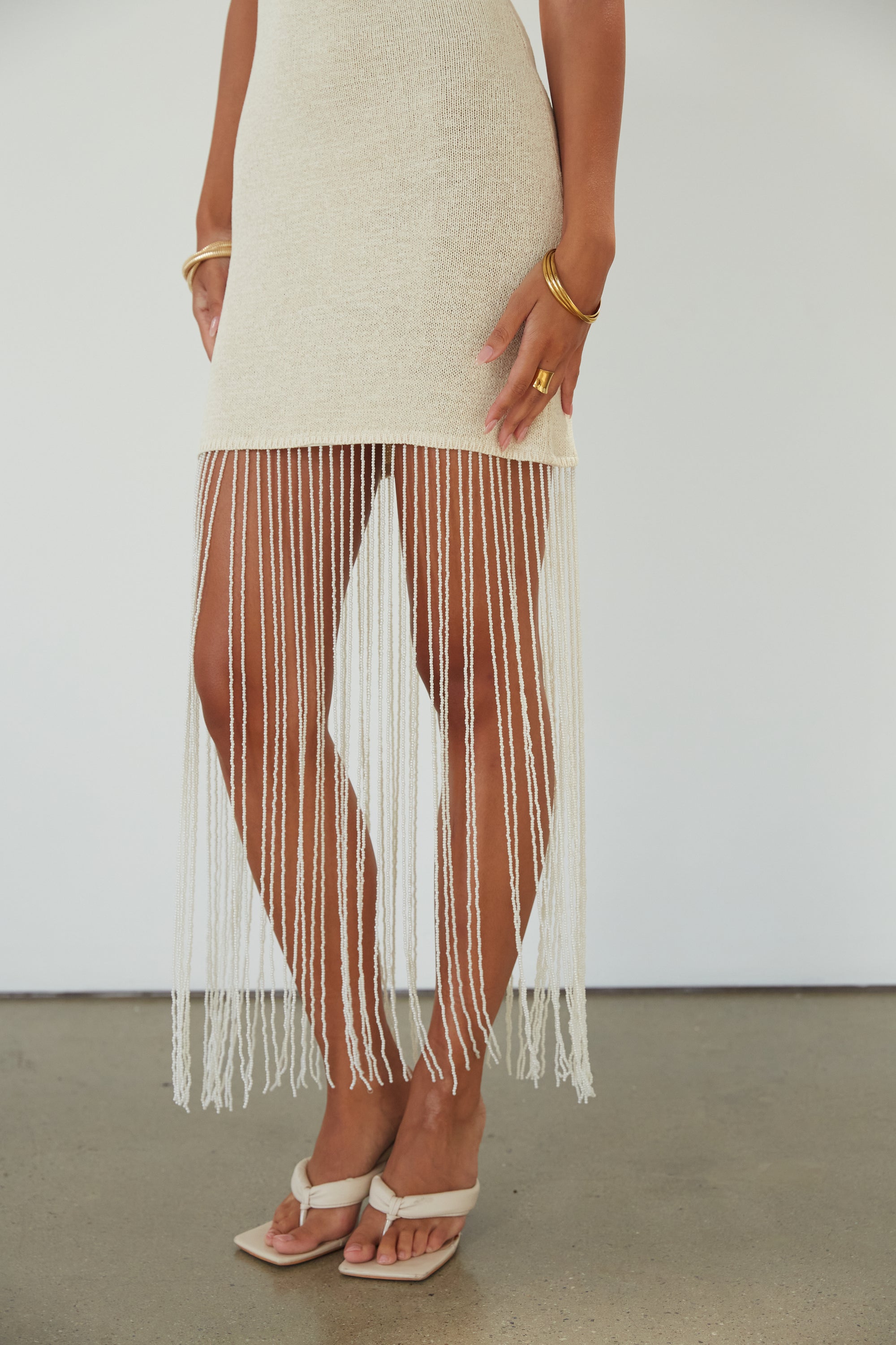 Crochet knit dress. Adjustable straps. Beaded fringe hem. Unlined. beaded dress. bridal dress. bridal shower dress. cream mini dress.