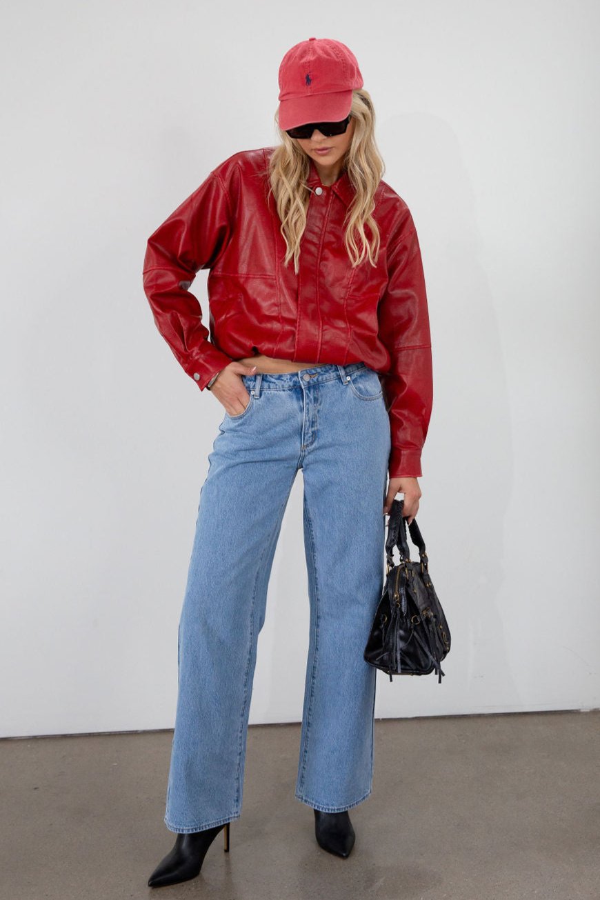 Red Vegan leather bomber jacket. Collar neckline. Snap button long sleeve closures. Front snap button down closures. Front pockets. Elastic hem. Fully lined. fall jacket. fall outfit