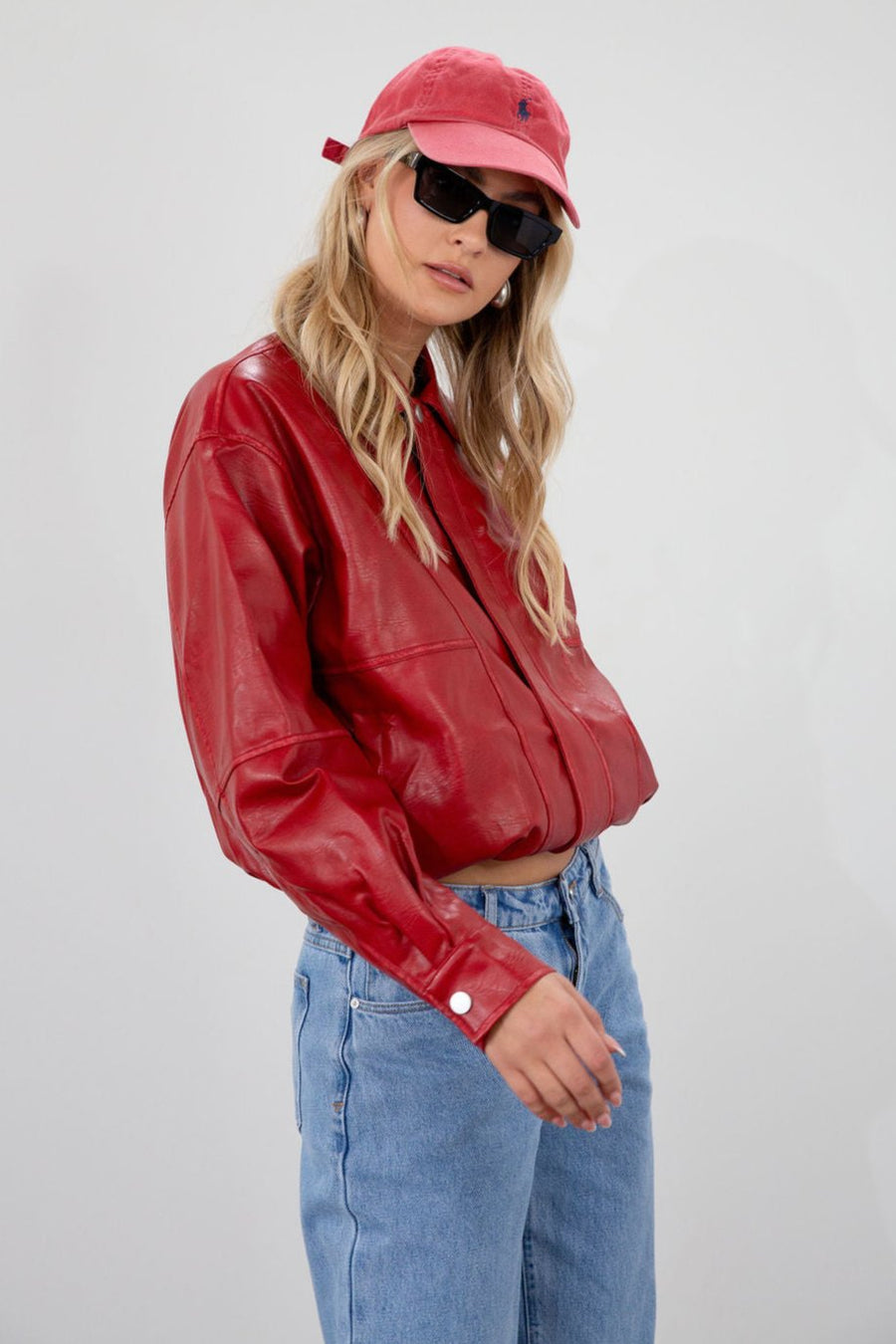 Red Vegan leather bomber jacket. Collar neckline. Snap button long sleeve closures. Front snap button down closures. Front pockets. Elastic hem. Fully lined. fall jacket. fall outfit