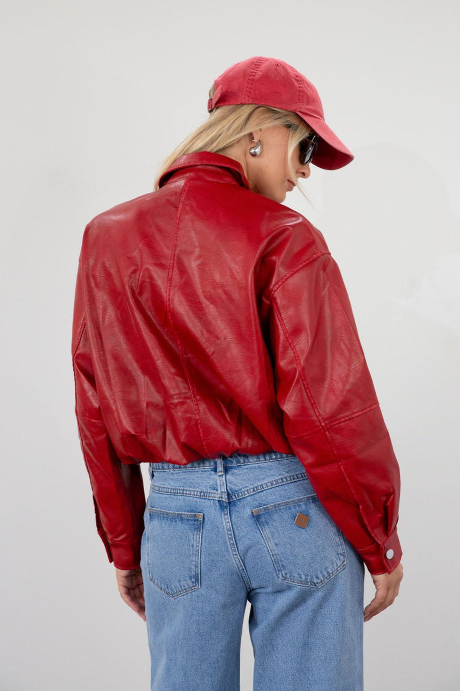 Red Vegan leather bomber jacket. Collar neckline. Snap button long sleeve closures. Front snap button down closures. Front pockets. Elastic hem. Fully lined. fall jacket. fall outfit
