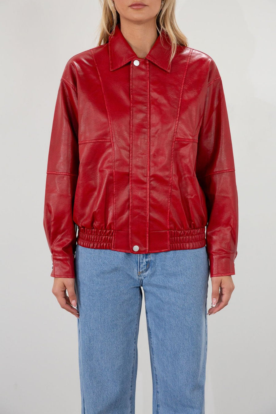 Red Vegan leather bomber jacket. Collar neckline. Snap button long sleeve closures. Front snap button down closures. Front pockets. Elastic hem. Fully lined. fall jacket. fall outfit