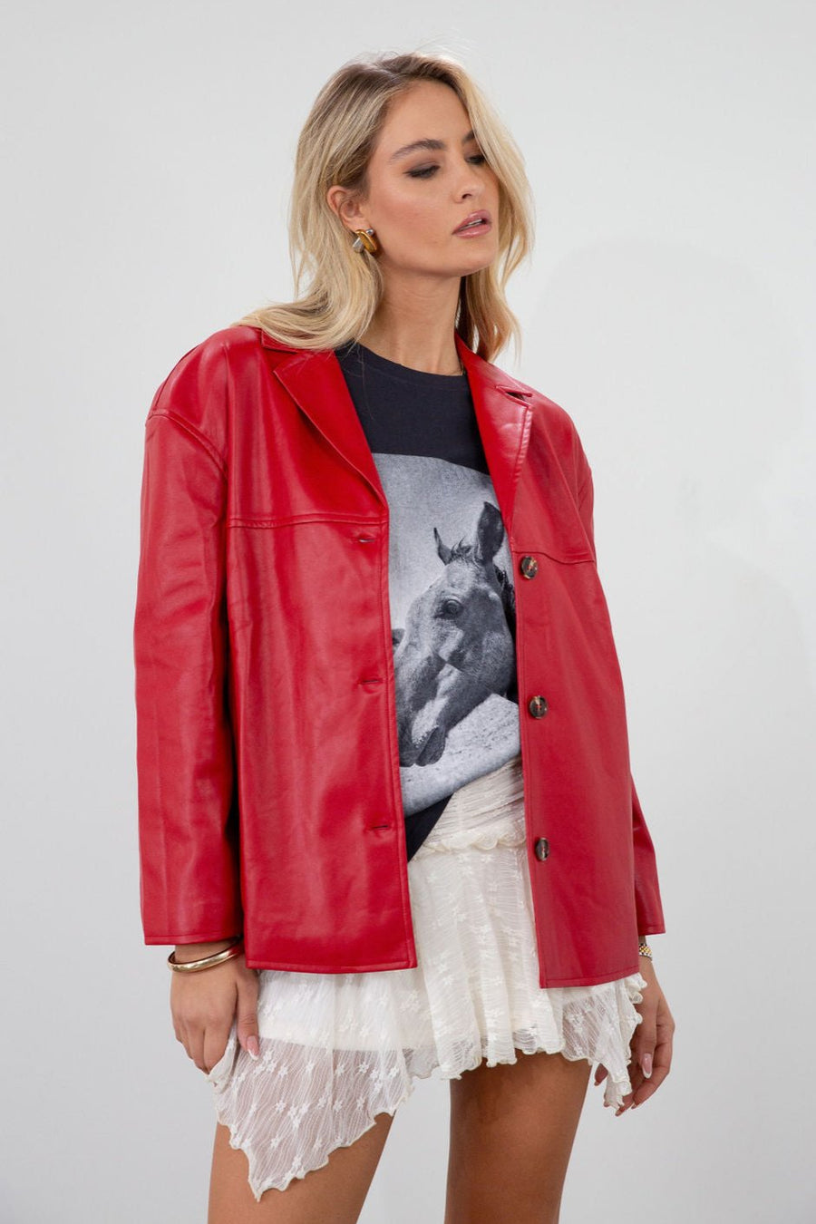 Vegan leather blazer. Single breast. Collar neckline. Front button down closure. Side pockets. Back slit. Fully lined. red leather blazer