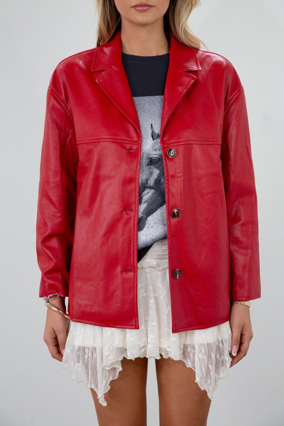 Vegan leather blazer. Single breast. Collar neckline. Front button down closure. Side pockets. Back slit. Fully lined. red leather blazer