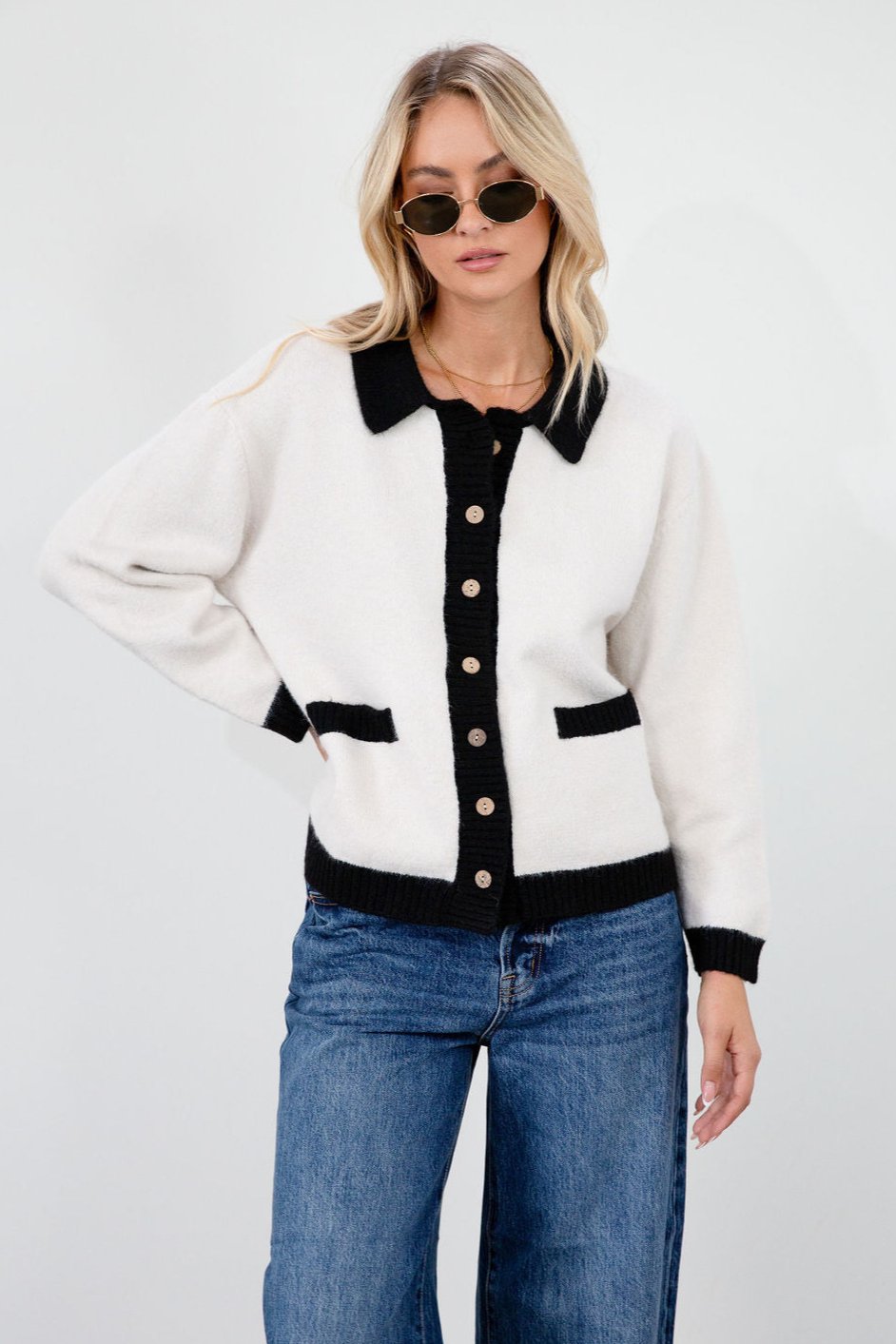Colorblocked fuzzy crochet knit cardigan. Collar neckline. Front button down closure. Front pockets. Unlined. white cardigan. white and black cardigan. fall sweater. fall outfit. classy cardigan sweater. cardigan sweater