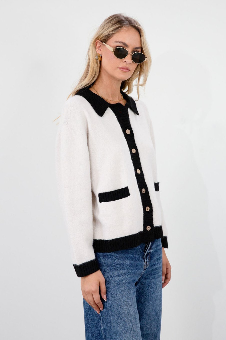 Colorblocked fuzzy crochet knit cardigan. Collar neckline. Front button down closure. Front pockets. Unlined. white cardigan. white and black cardigan. fall sweater. fall outfit. classy cardigan sweater. cardigan sweater