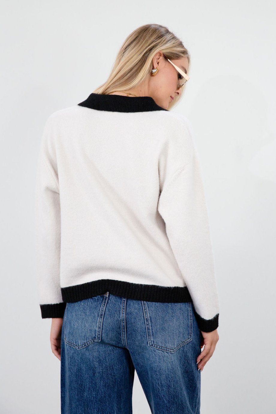 Colorblocked fuzzy crochet knit cardigan. Collar neckline. Front button down closure. Front pockets. Unlined. white cardigan. white and black cardigan. fall sweater. fall outfit. classy cardigan sweater. cardigan sweater