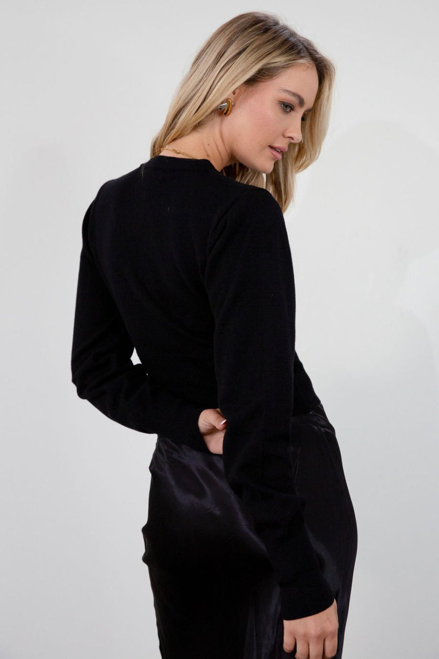Black knit cardigan. Long sleeves. Front button down closure. Banded hems. Unlined. fall top. fall outfit. holiday outfit.